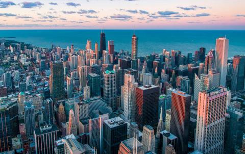 Aerial view of Chicago's downtown skyline at sunset next to the lake