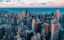 Aerial view of Chicago's downtown skyline at sunset next to the lake