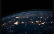 Earth at night viewed from space, showing city lights